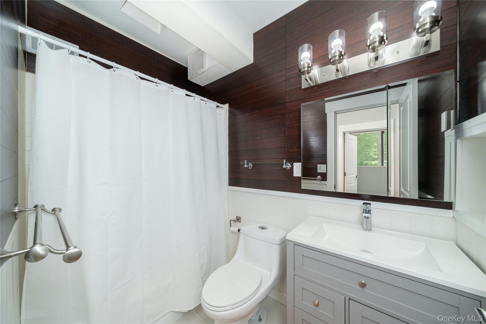 4 Half Mile Road Armonk, NY 10504 - Photo 17 of 28 Updated hallway bathroom featuring modern finishes, and a clean, contemporary design.