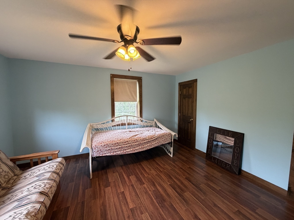271 Lower Road Deerfield, MA 01342 - Photo 25 of 40 a bedroom with a bed and wooden floor