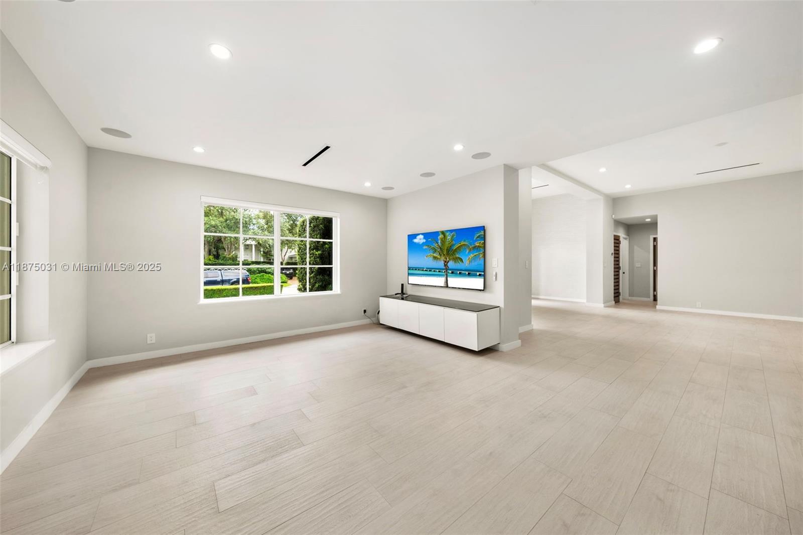 4380 Lake Road Miami, FL 33137 - Photo 13 of 61 a view of a livingroom with wooden floor and white walls
