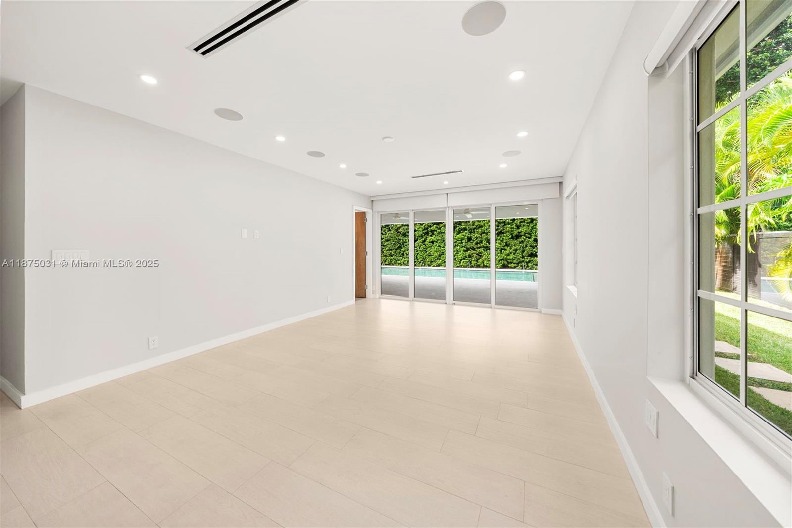 4380 Lake Road Miami, FL 33137 - Photo 27 of 61 an empty room with windows and garden