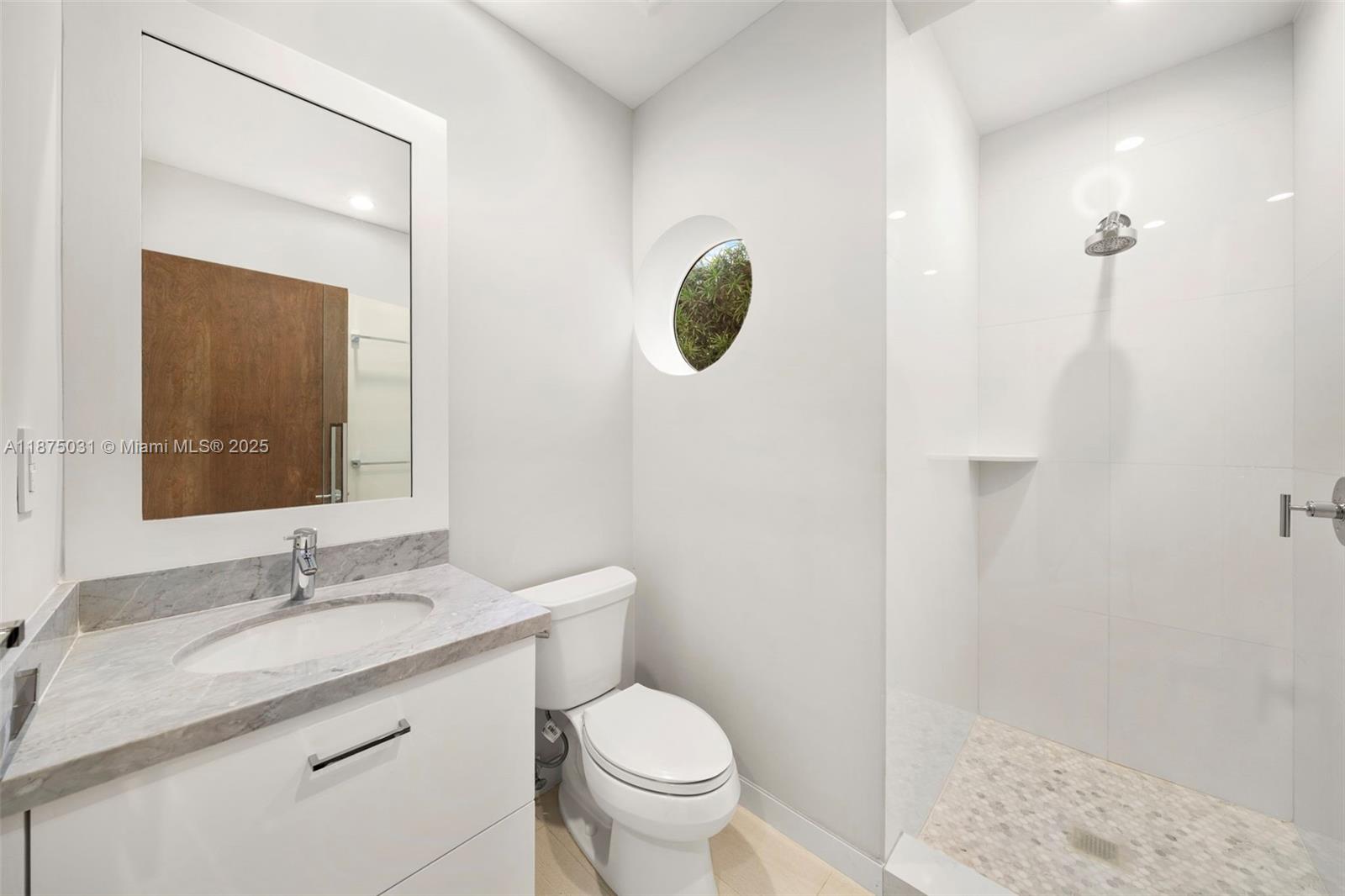 4380 Lake Road Miami, FL 33137 - Photo 37 of 61 a bathroom with a granite countertop sink toilet and shower