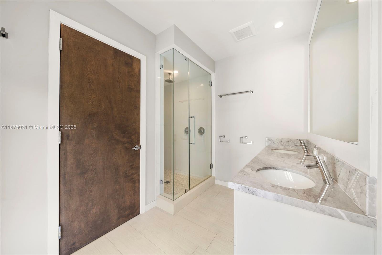 4380 Lake Road Miami, FL 33137 - Photo 41 of 61 a bathroom with a granite countertop sink a shower and a mirror