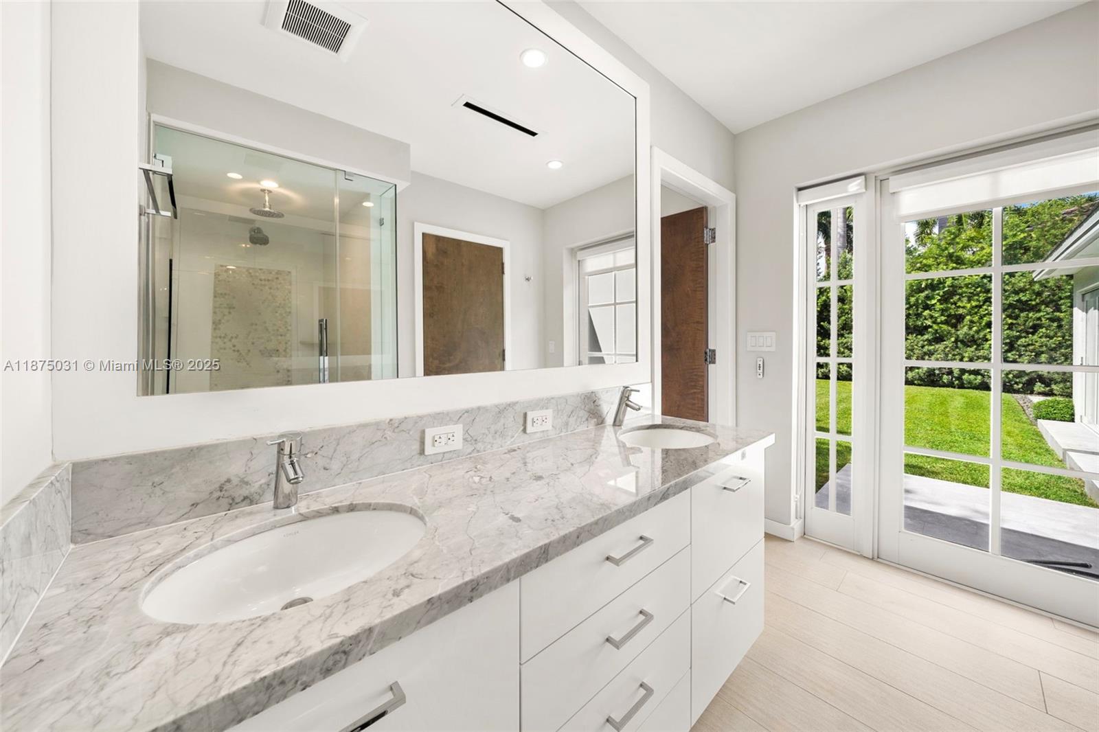 4380 Lake Road Miami, FL 33137 - Photo 43 of 61 a bathroom with a granite countertop sink and a large mirror