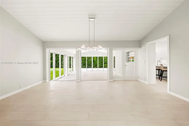 a view of an empty room with windows and balcony