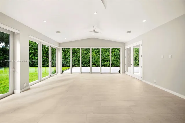 a kitchen with stainless steel appliances kitchen island granite countertop a refrigerator and a stove top oven