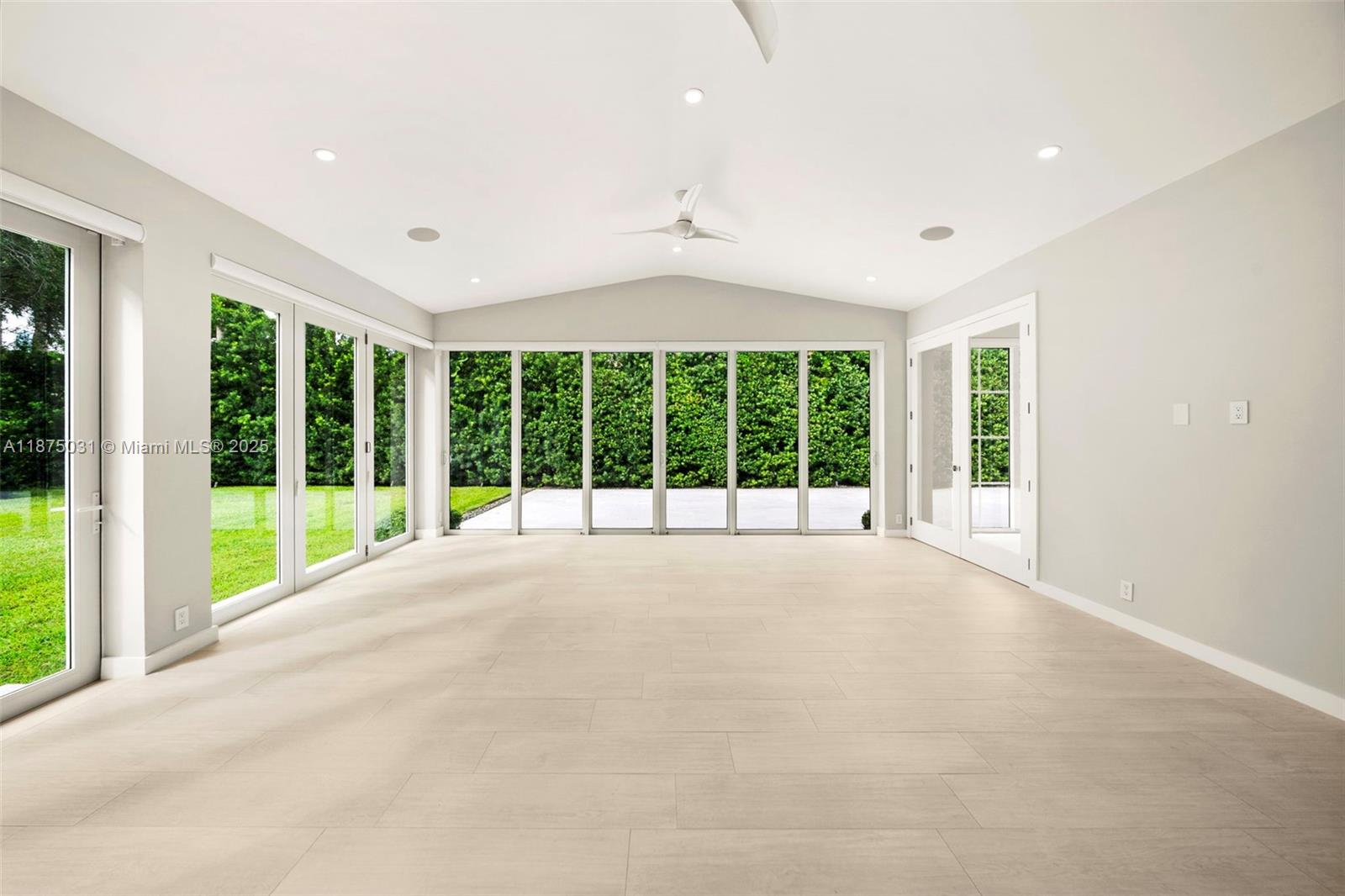 4380 Lake Road Miami, FL 33137 - Photo 7 of 61 a view of an empty room with wooden floor and a large window