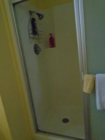 a bedroom with a bed and a flat tv screen