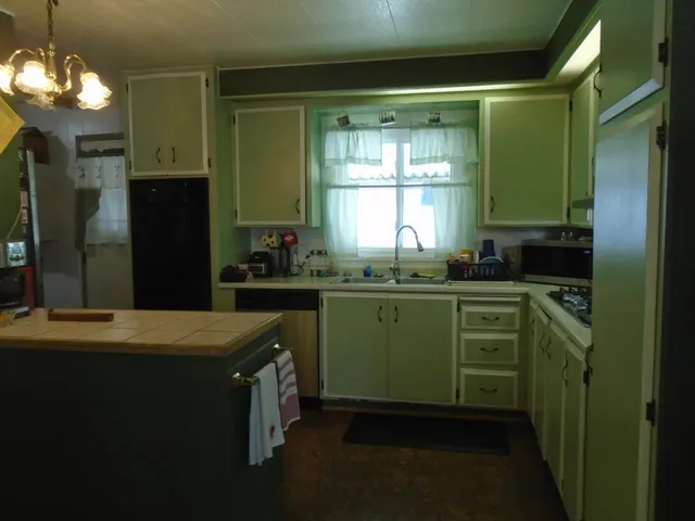 a kitchen with a sink and cabinets