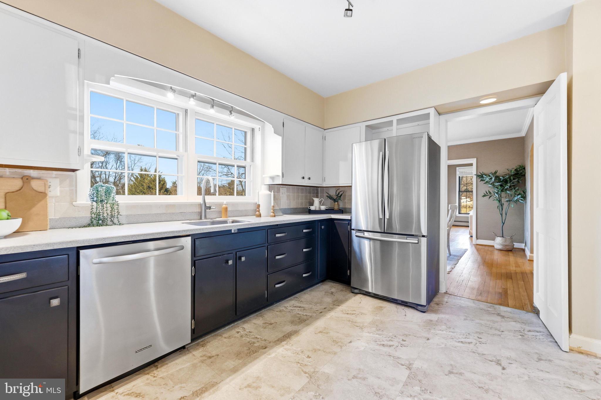 9101 Warfield Road Gaithersburg, MD 20882 - Photo 17 of 44 a kitchen with a refrigerator sink and cabinets