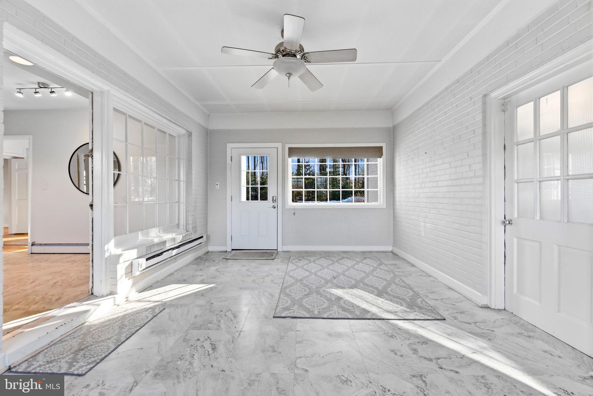 9101 Warfield Road Gaithersburg, MD 20882 - Photo 22 of 44 a view of a livingroom with a ceiling fan and window