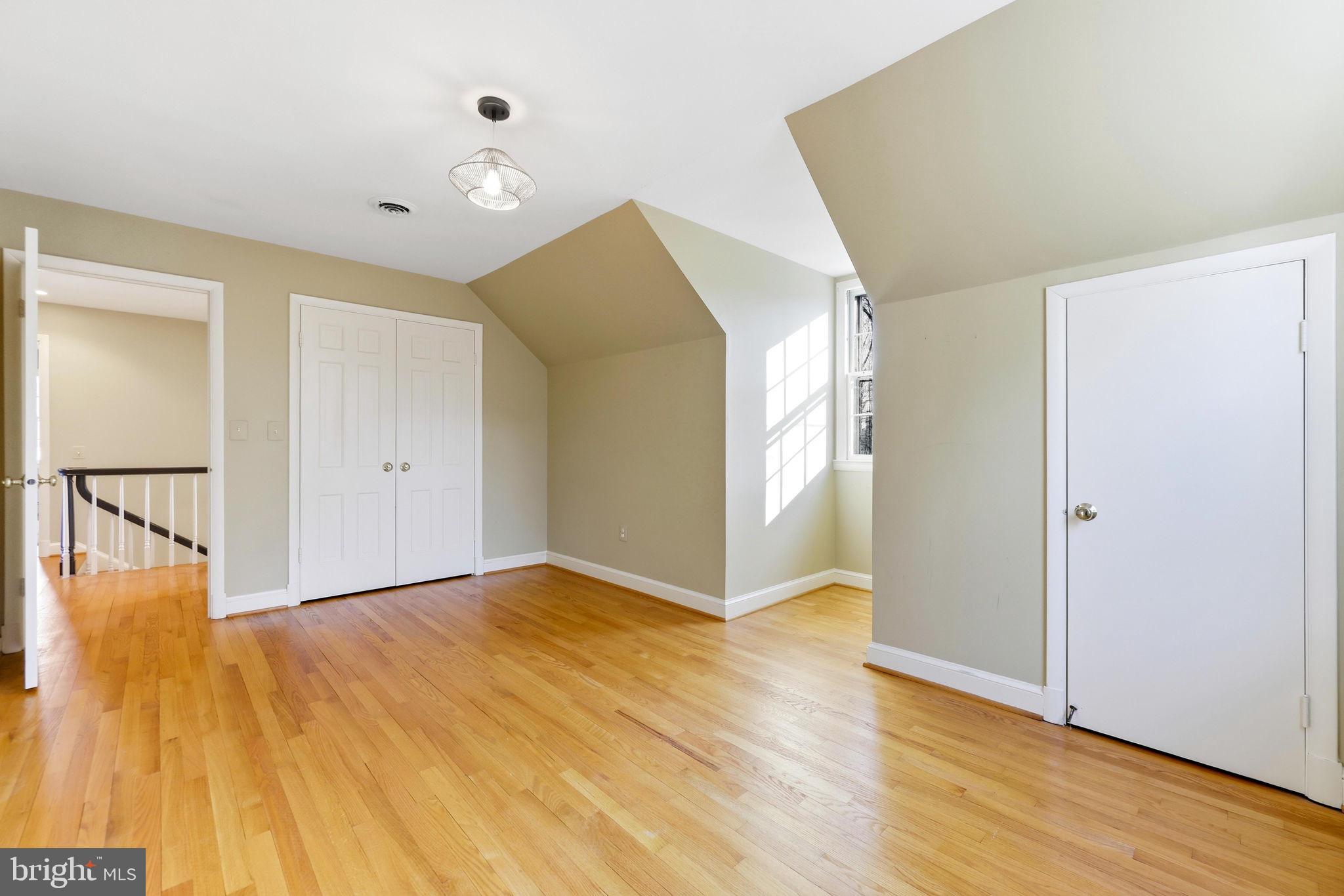 9101 Warfield Road Gaithersburg, MD 20882 - Photo 28 of 44 a view of an empty room with wooden floor