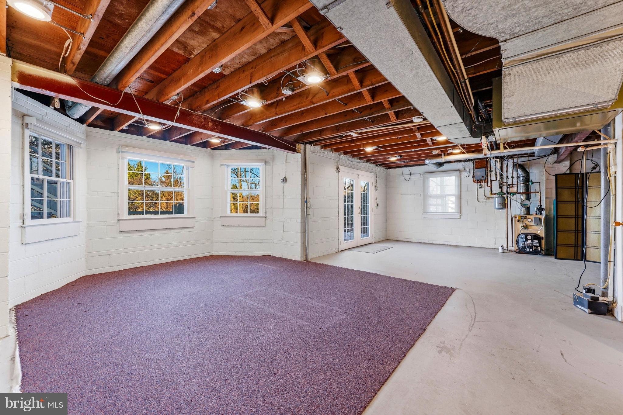 9101 Warfield Road Gaithersburg, MD 20882 - Photo 32 of 44 a view of an empty room with windows