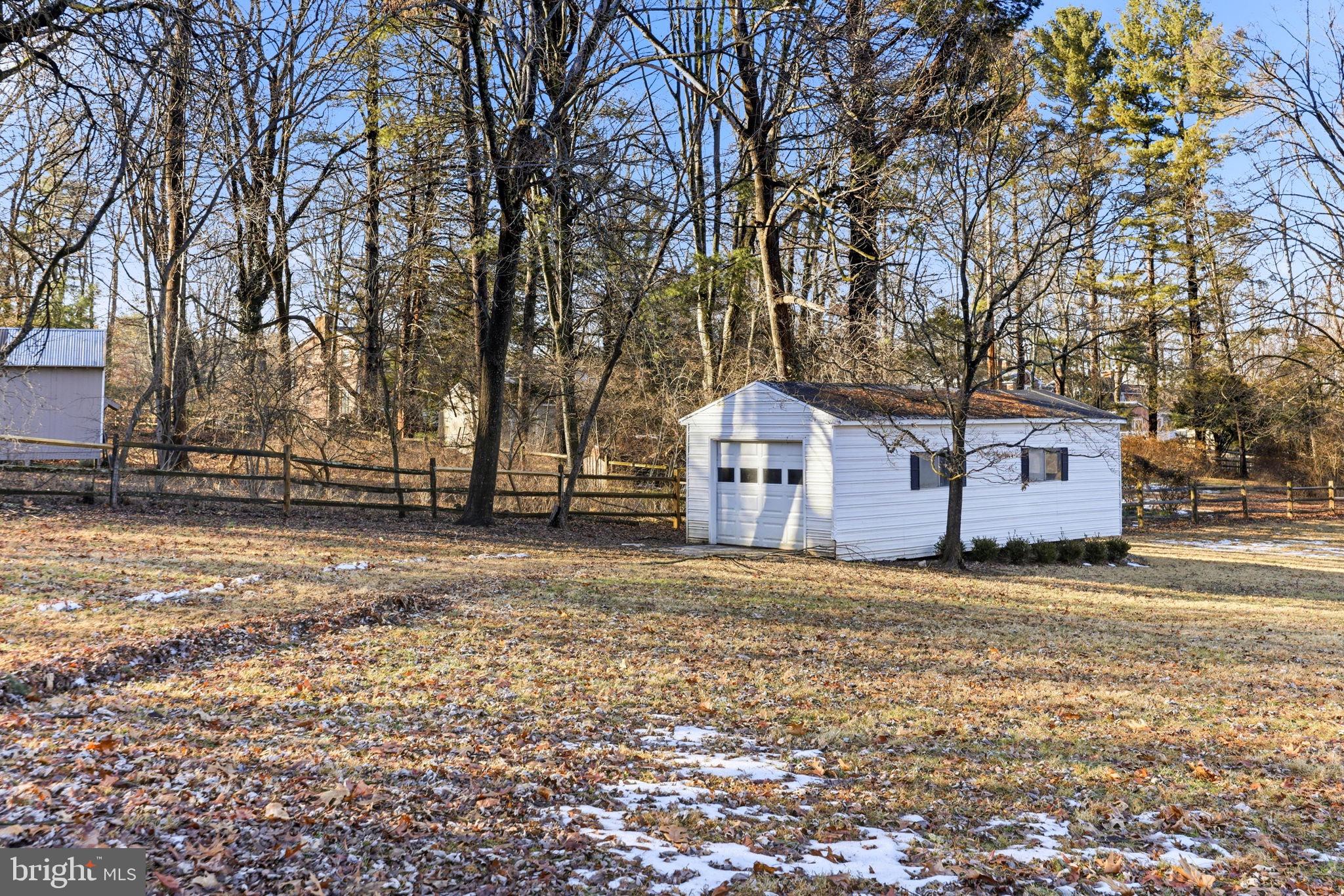 9101 Warfield Road Gaithersburg, MD 20882 - Photo 38 of 44 a house that has a tree in front of it