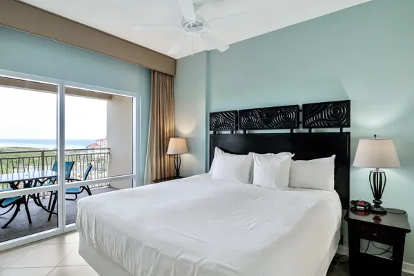 a bedroom with a bed a large window and walk in closet