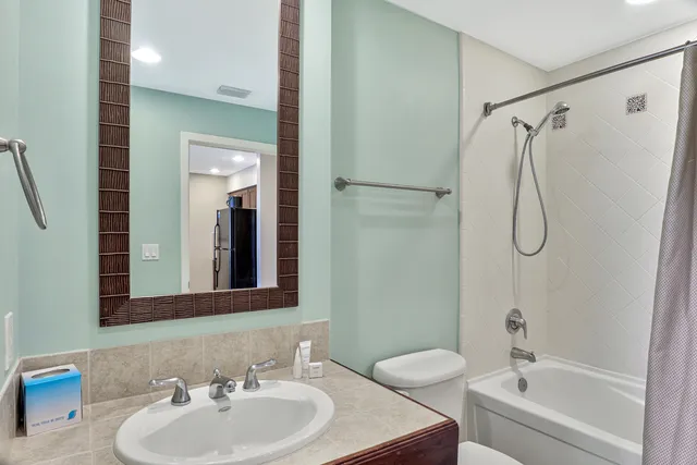 a living room with flat screen tv and gym equipment