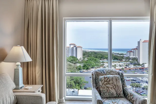 a view of a hallway with furniture and wooden floor