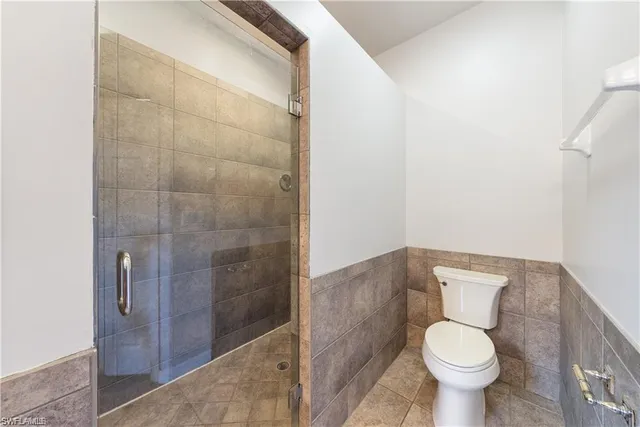 a bathroom with a granite countertop bathtub sink vanity and mirror