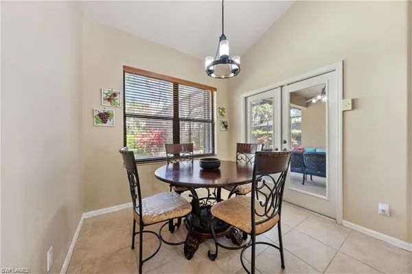 a kitchen with stainless steel appliances a table and chairs