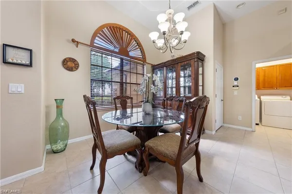 a living room with furniture a large window and a flat screen tv