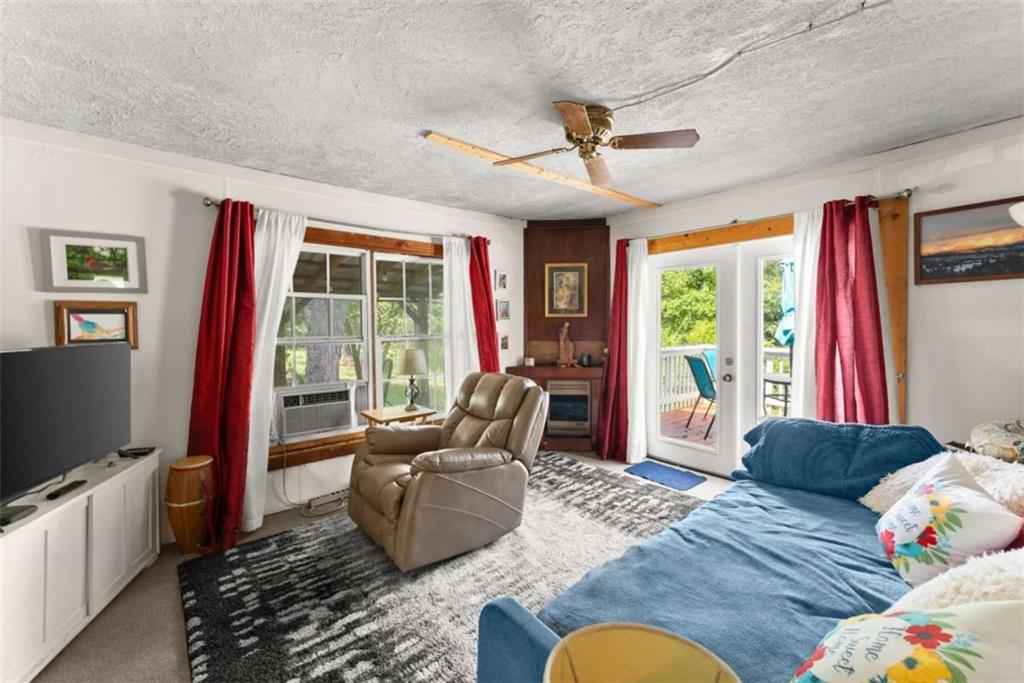 1542 Marlow Road Maysville, GA 30558 - Photo 6 of 35 a living room with furniture and a flat screen tv