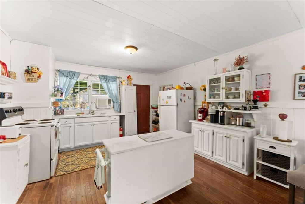 1542 Marlow Road Maysville, GA 30558 - Photo 7 of 35 a kitchen with stainless steel appliances a stove top oven a sink a refrigerator cabinets and wooden floor