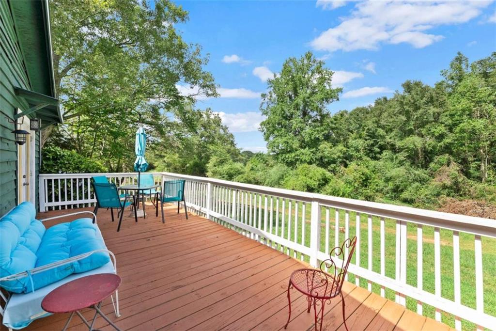 1542 Marlow Road Maysville, GA 30558 - Photo 10 of 35 a balcony with wooden floor table and chairs