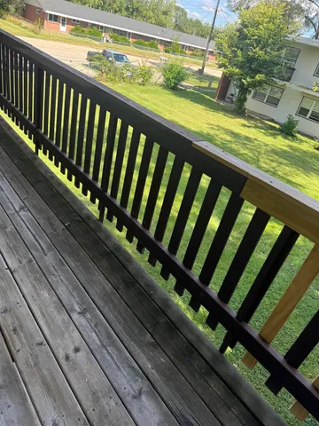a view of a balcony with wooden floor
