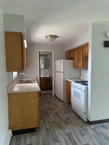 a kitchen with a refrigerator sink and stove
