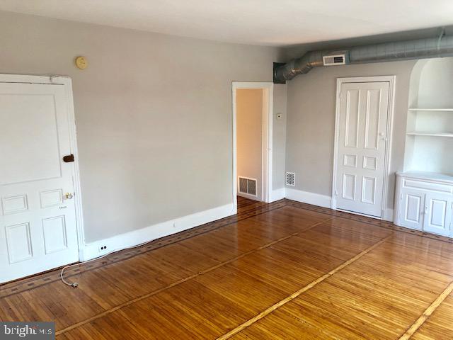 2021 Spring Garden Street, Unit 3F Philadelphia, PA 19130 - Photo 11 of 22 a view of an empty room with wooden floor and a window