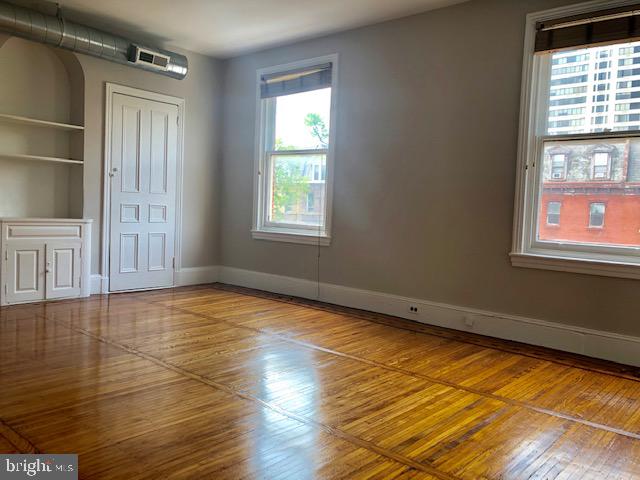 2021 Spring Garden Street, Unit 3F Philadelphia, PA 19130 - Photo 4 of 22 an empty room with wooden floor and windows