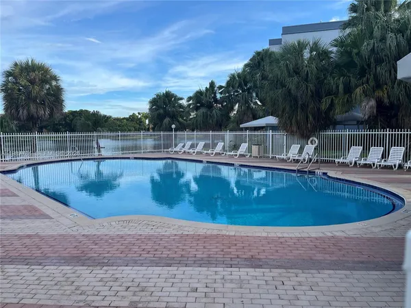 a view of a swimming pool with a yard