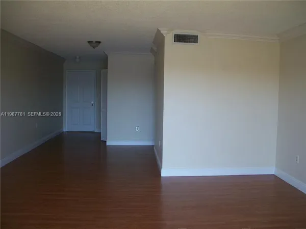 a view of a room with wooden floor