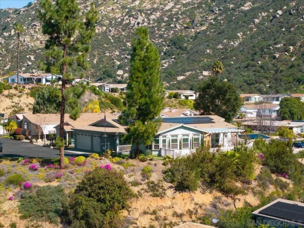 a front view of a house with a yard and fountain