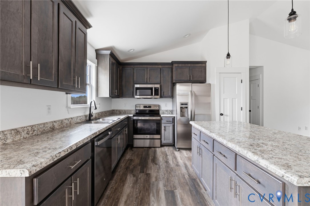 5245 Courtland Road Disputanta, VA 23842 - Photo 10 of 27 a kitchen with granite countertop a sink stove and refrigerator