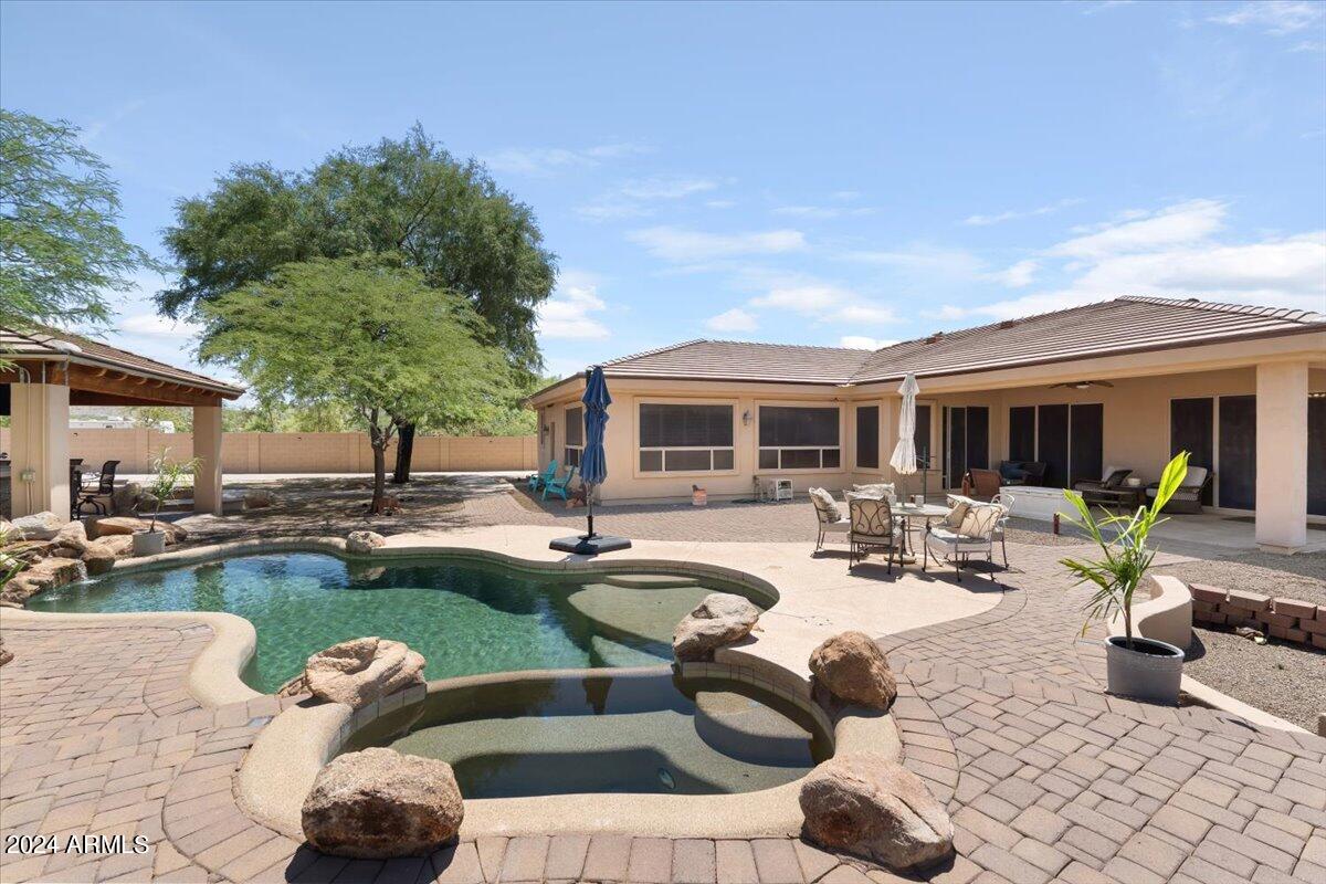 a view of a house with swimming pool and porch with furniture