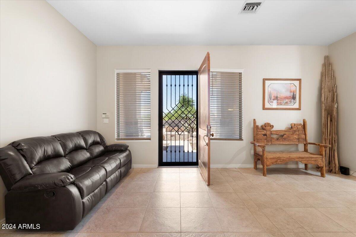 1706 West Parsons Road Phoenix, AZ 85085 - Photo 18 of 58 a living room with furniture and a flat screen tv