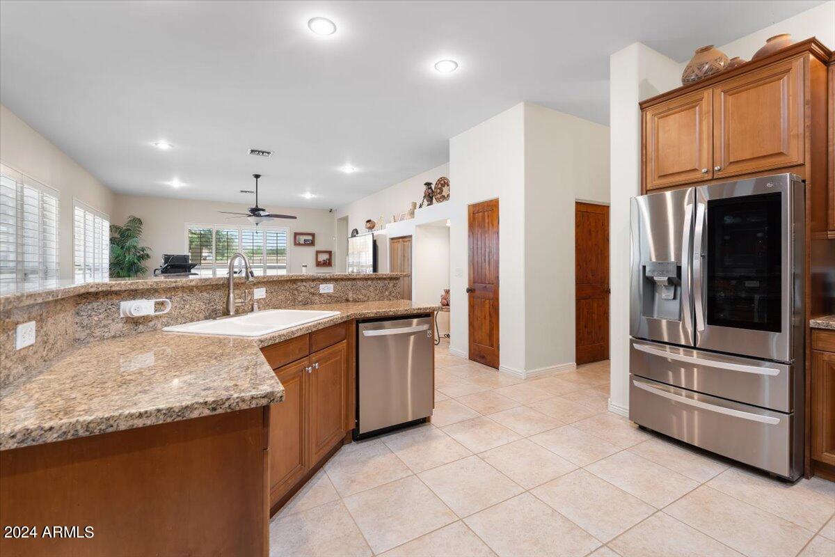 1706 West Parsons Road Phoenix, AZ 85085 - Photo 25 of 58 a kitchen with stainless steel appliances granite countertop a refrigerator and a sink