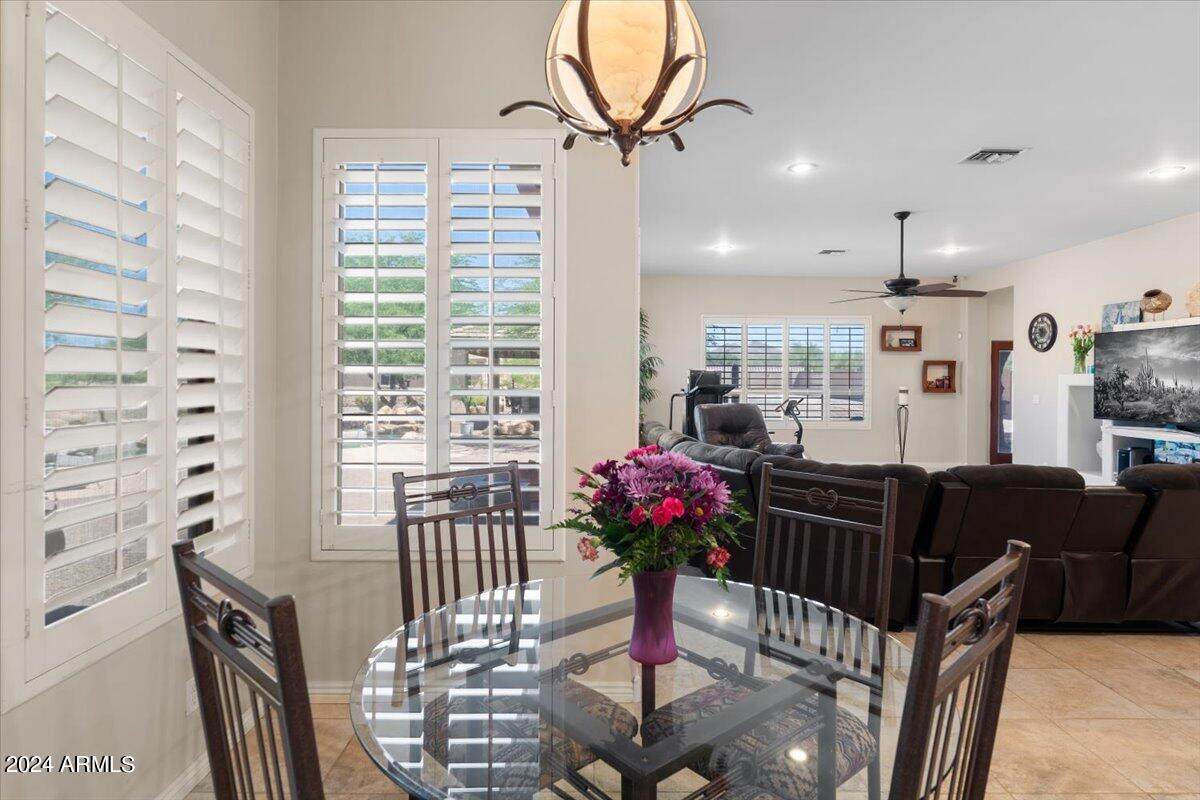 1706 West Parsons Road Phoenix, AZ 85085 - Photo 28 of 58 a living room with furniture a chandelier and a view of kitchen