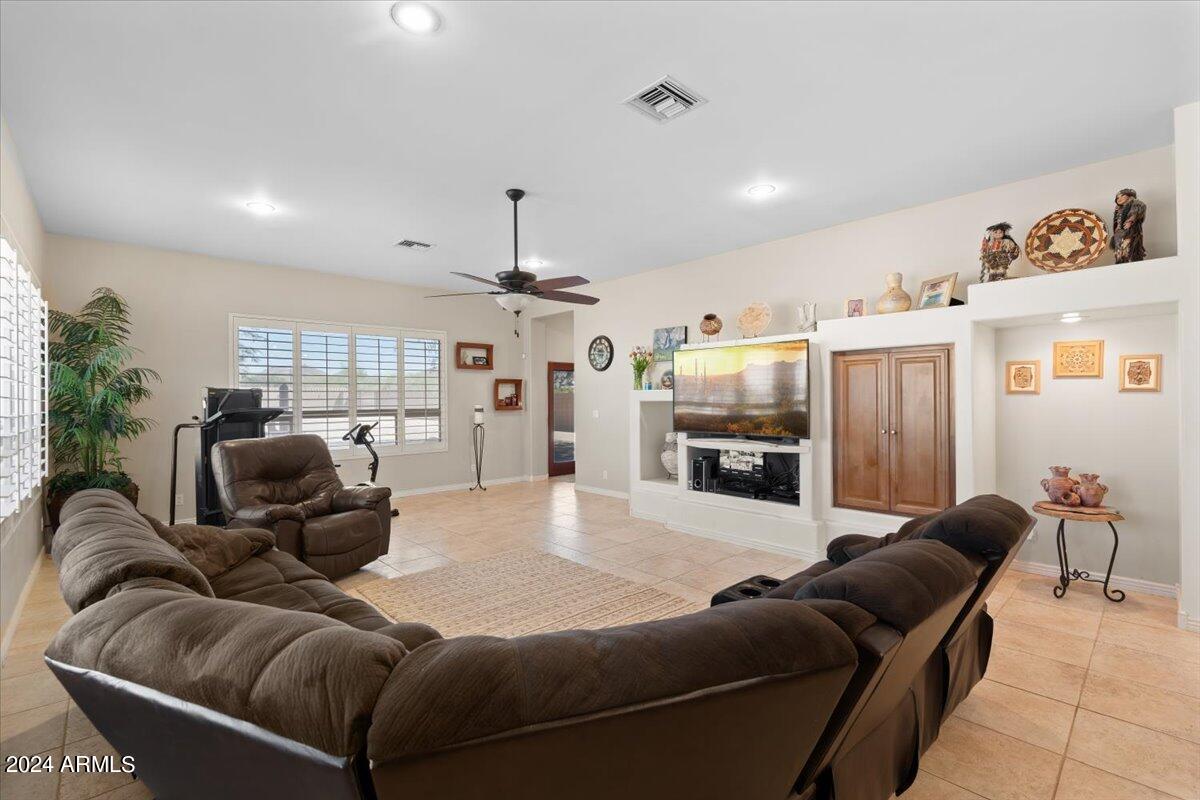 1706 West Parsons Road Phoenix, AZ 85085 - Photo 29 of 58 a living room with furniture and a flat screen tv