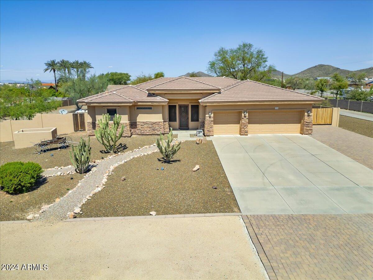 1706 West Parsons Road Phoenix, AZ 85085 - Photo 3 of 58 a view of a house with a yard and potted plants