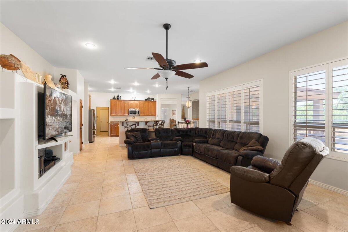 1706 West Parsons Road Phoenix, AZ 85085 - Photo 31 of 58 a living room with furniture and a flat screen tv