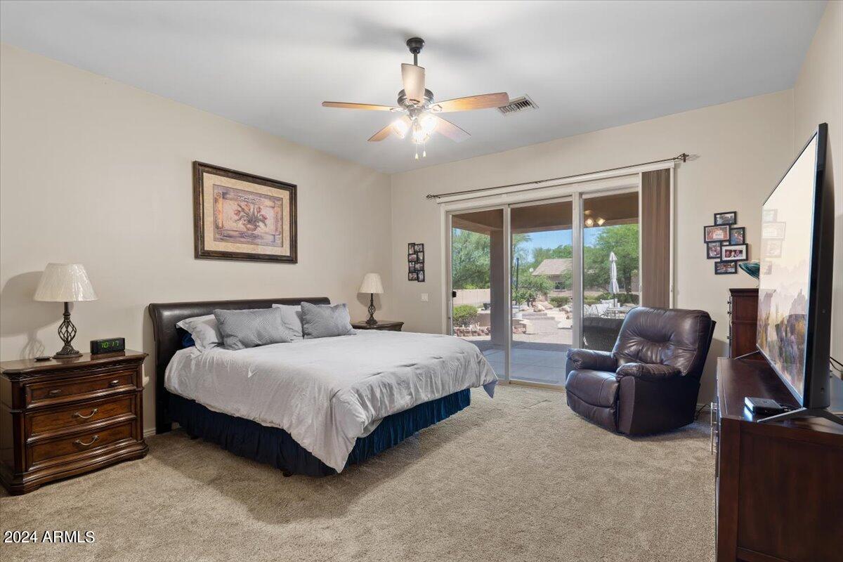 1706 West Parsons Road Phoenix, AZ 85085 - Photo 32 of 58 a bedroom with a bed and a couch