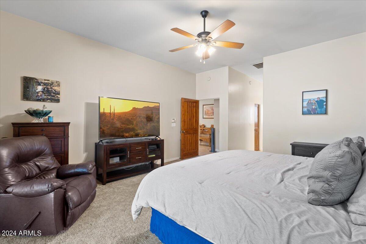 1706 West Parsons Road Phoenix, AZ 85085 - Photo 34 of 58 a bedroom with a bed and a flat screen tv