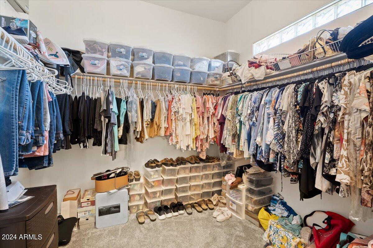 1706 West Parsons Road Phoenix, AZ 85085 - Photo 38 of 58 a view of walk in closet with clothes and shoes