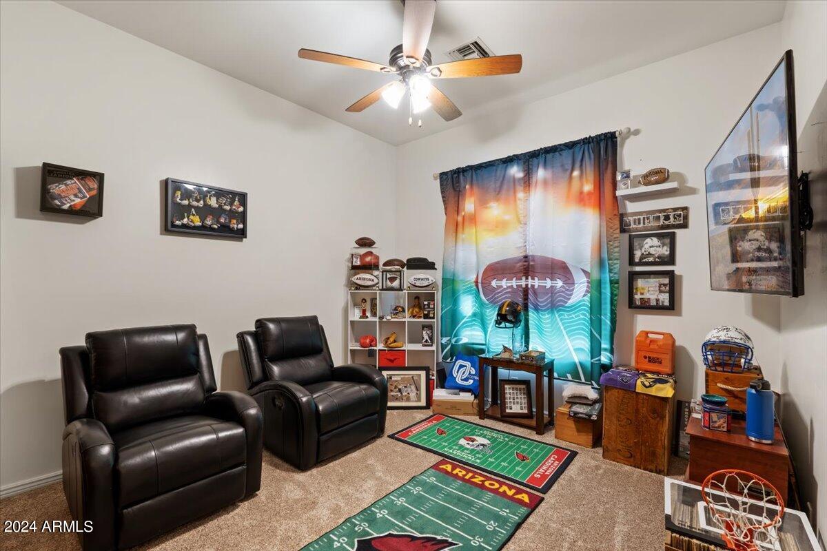 1706 West Parsons Road Phoenix, AZ 85085 - Photo 39 of 58 a living room with furniture and a flat screen tv