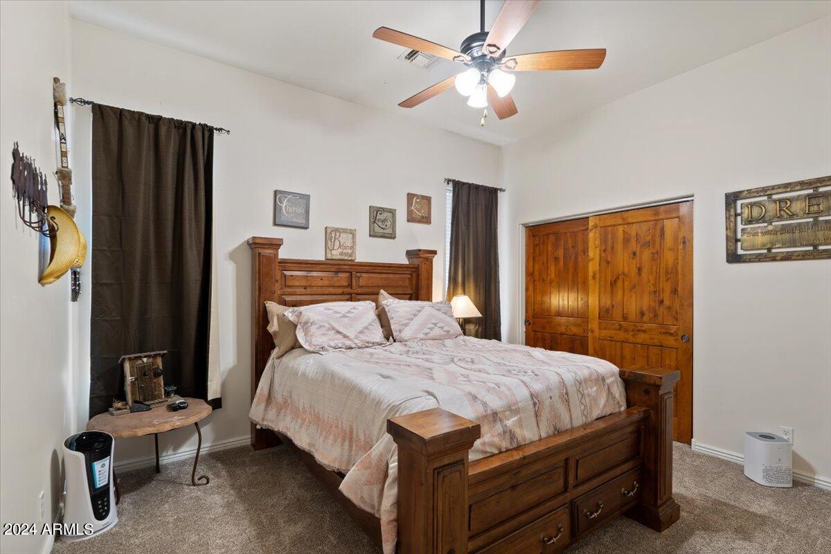 1706 West Parsons Road Phoenix, AZ 85085 - Photo 40 of 58 a bedroom with a bed and a chandelier