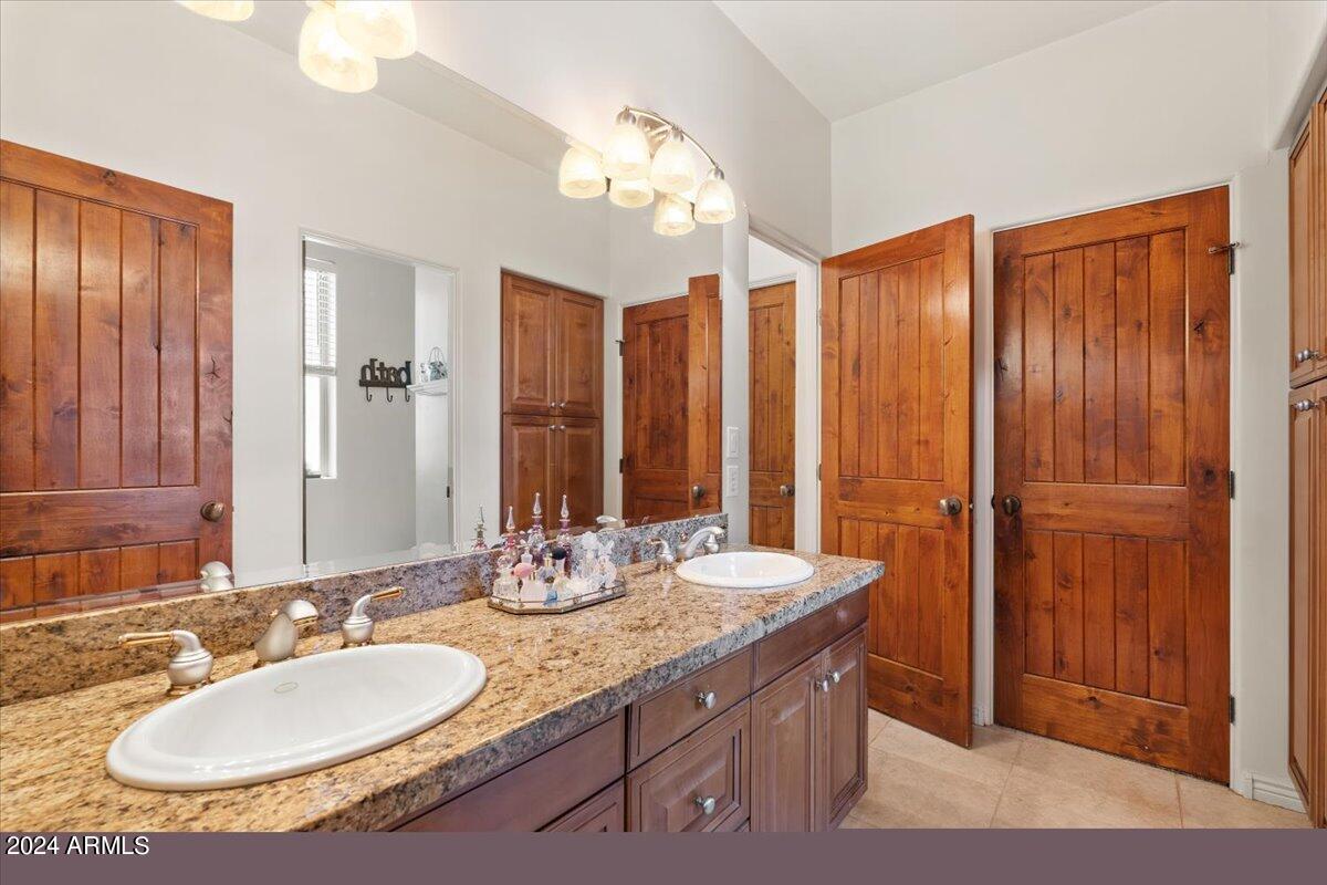 1706 West Parsons Road Phoenix, AZ 85085 - Photo 41 of 58 a bathroom with a double vanity sink and a mirror