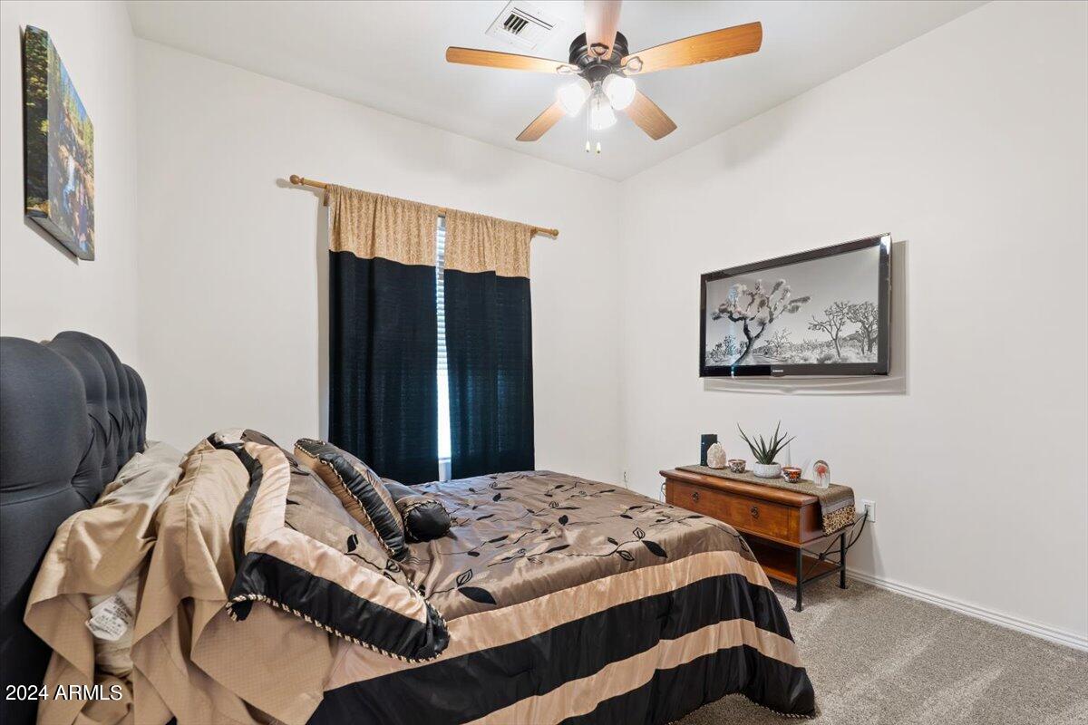 1706 West Parsons Road Phoenix, AZ 85085 - Photo 43 of 58 a bedroom with bed and wooden floor