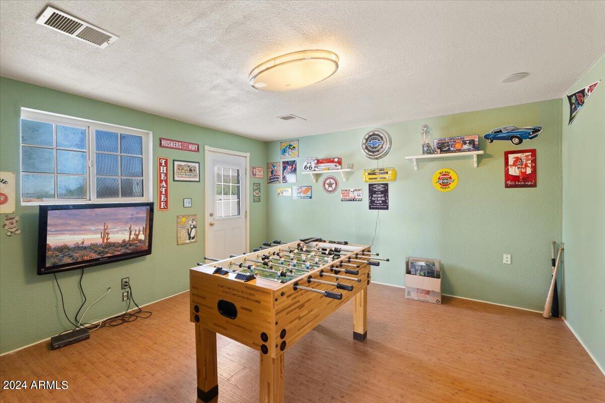 1706 West Parsons Road Phoenix, AZ 85085 - Photo 48 of 58 a living room with furniture and a flat screen tv