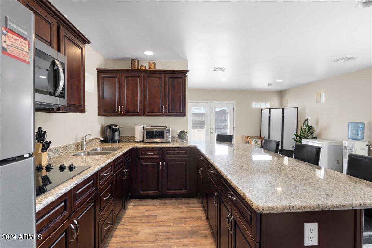 1706 West Parsons Road Phoenix, AZ 85085 - Photo 54 of 58 a kitchen with stainless steel appliances granite countertop a sink stove and refrigerator